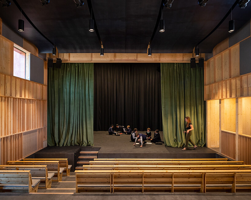 jonathan tuckey design completes red theater as part of school campus in south east england