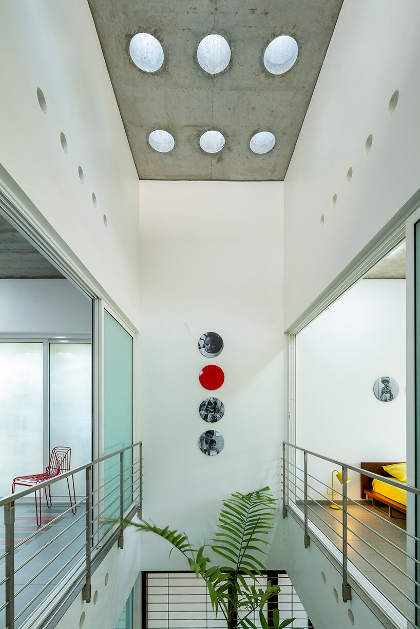 'house that rains light' by LIJO.RENY.architects is overflowing with greenery in kerala, india