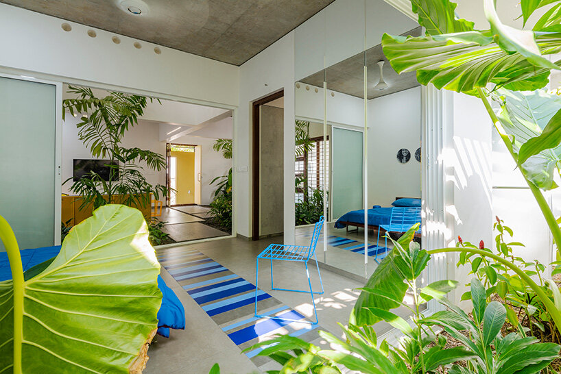 'house that rains light' by LIJO.RENY.architects is overflowing with greenery in kerala, india