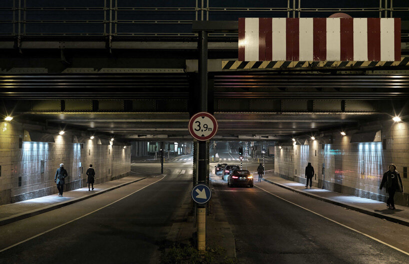 passersby activate dynamic projections in matthias oostrik's light installation in amsterdam