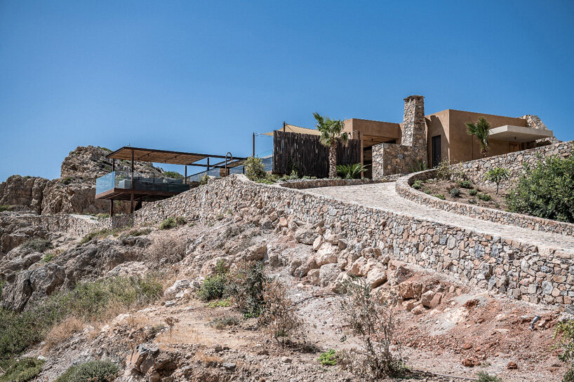 paly architects sets holiday residence on a steep rocky slope in crete, greece