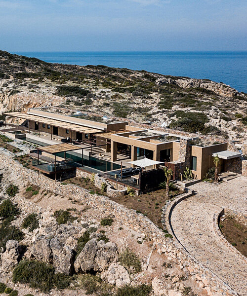 paly architects sets holiday residence on a steep rocky slope in crete, greece