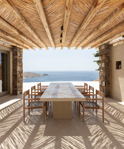 sinas architects embeds a snaking stone summer house into serifos island in greece