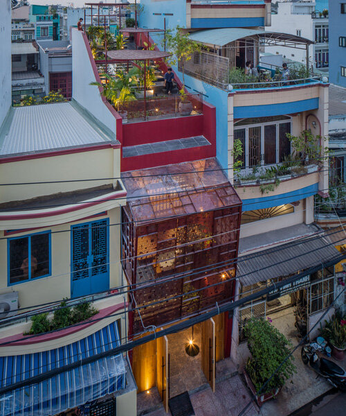 AD9 architects completes vietnamese house with perforated façade + sloped roof garden