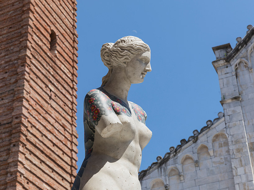 fabio viale sets tattooed and carved marble sculptures across the tuscan town of pietrasanta