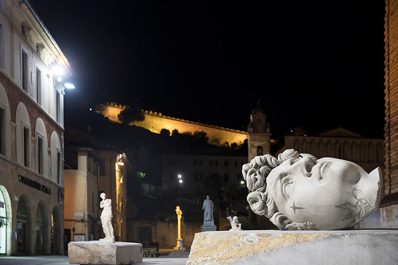 fabio viale sets tattooed and carved marble sculptures across the tuscan town of pietrasanta