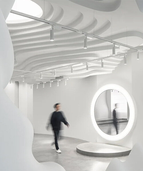 123 architects sets futuristic 'white cave' retail + gallery within central beijing