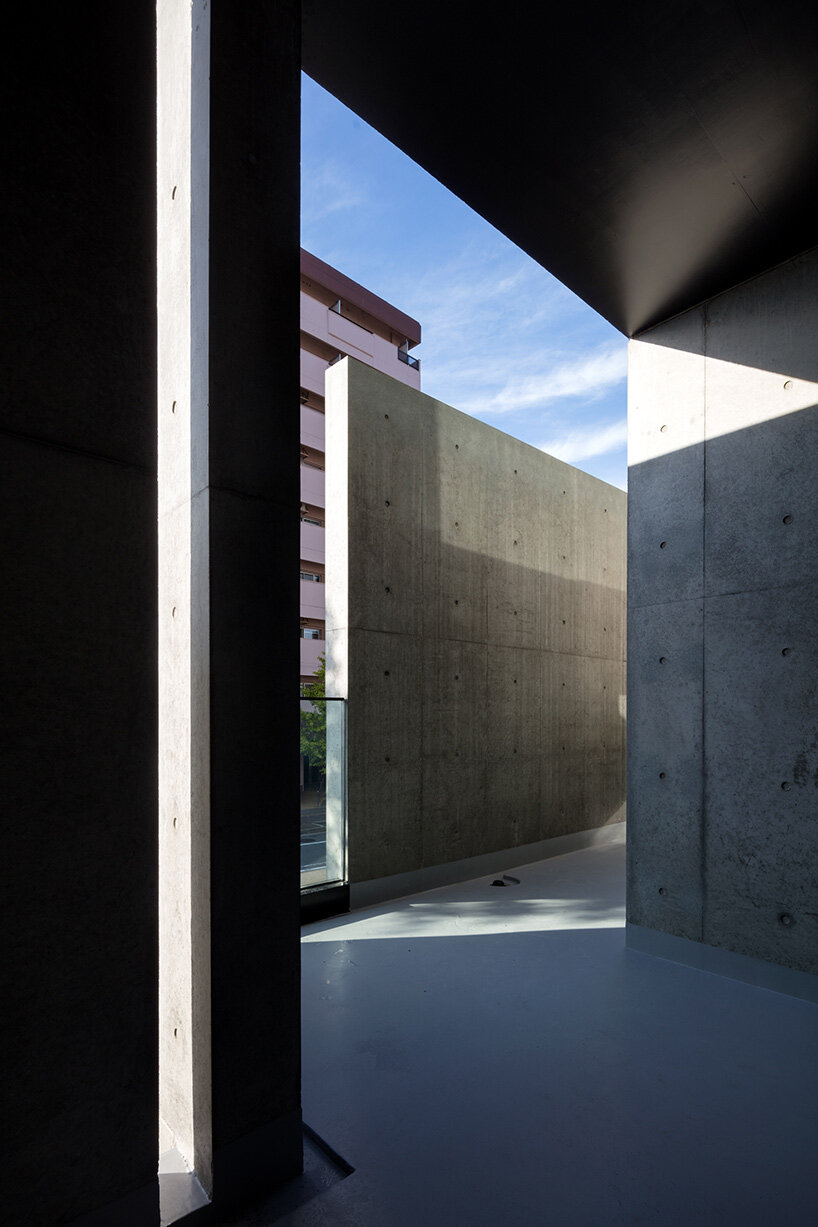 takuyahosokai's concrete housing complex in niigata contains 34 dwellings