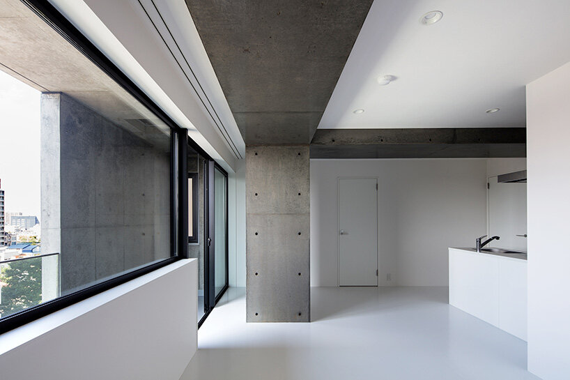 takuyahosokai's concrete housing complex in niigata contains 34 dwellings