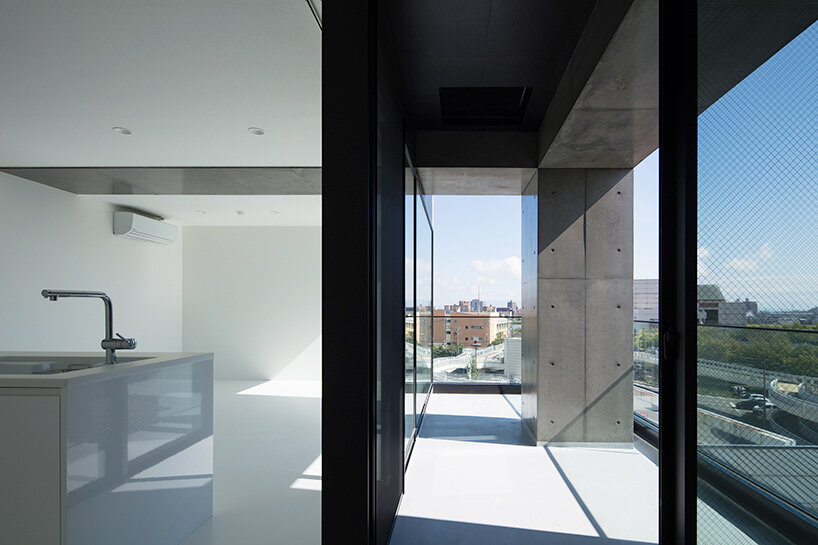 takuyahosokai's concrete housing complex in niigata contains 34 dwellings