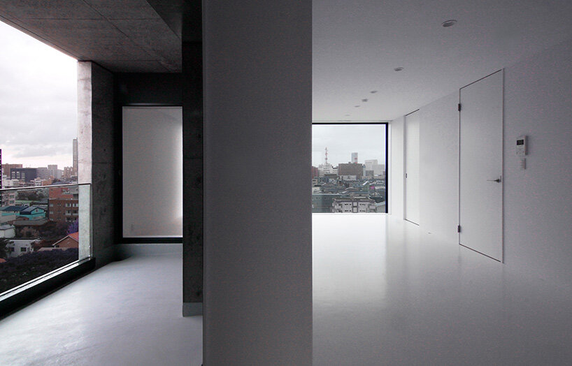 takuyahosokai's concrete housing complex in niigata contains 34 dwellings