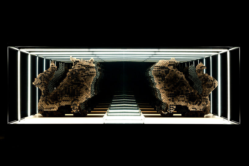 thousands of artificial wood pieces compose secca's puzzle sculpture 'A↔︎UN'