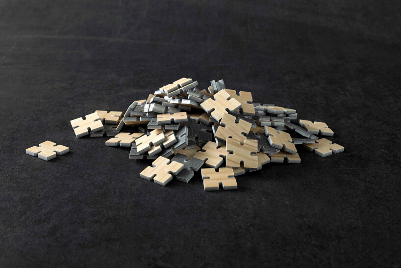 thousands of artificial wood pieces compose secca's puzzle sculpture 'A↔︎UN'