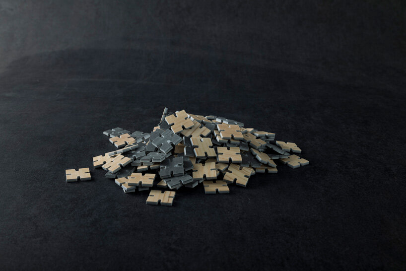 thousands of artificial wood pieces compose secca's puzzle sculpture 'A&#x2194;︎UN'
