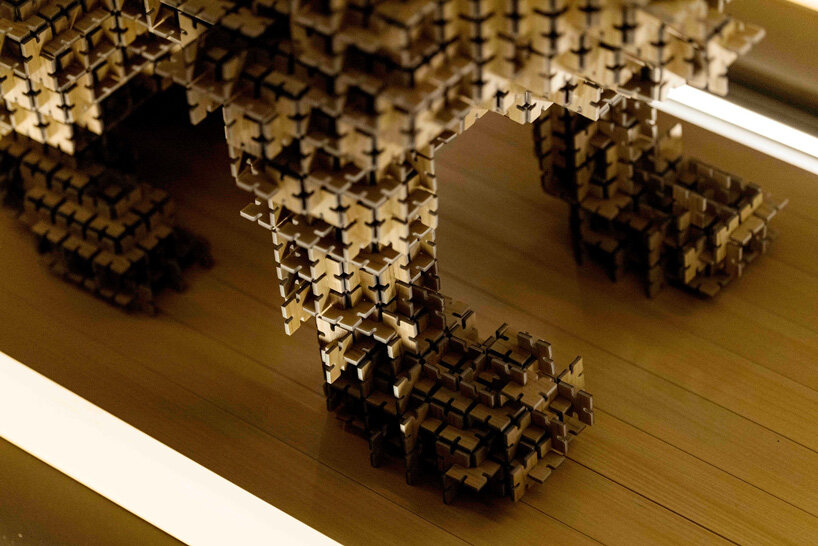 thousands of artificial wood pieces compose secca's puzzle sculpture 'A&#x2194;︎UN'
