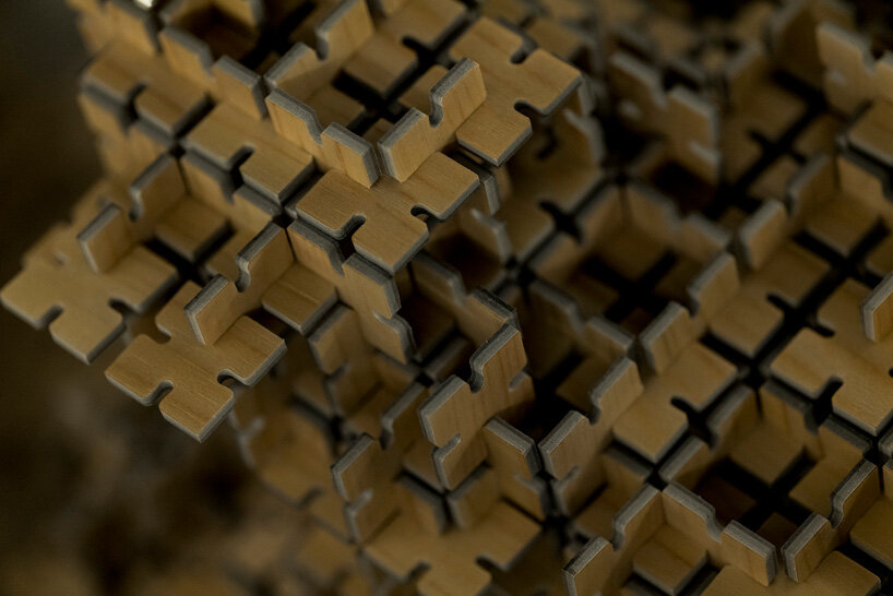 thousands of artificial wood pieces compose secca's puzzle sculpture 'A&#x2194;︎UN'