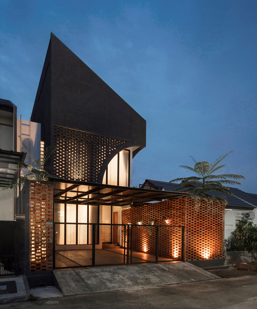 perforated brick and a pointed façade articulate elora house in indonesia