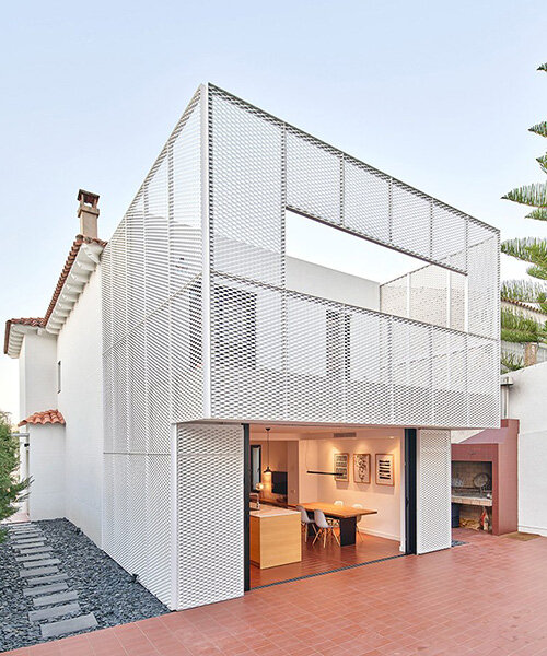 BONBA studio envelops residential extension in barcelona with lightweight metal mesh