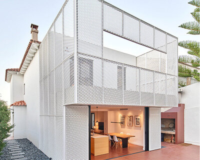 BONBA studio envelops residential extension in barcelona with lightweight metal mesh
