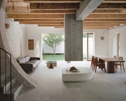 buchner bründler architekten converts basel carriage house into minimal concrete residence