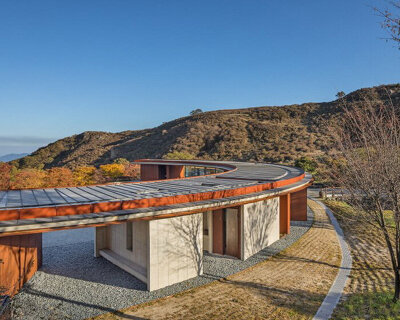 D.LIM architects blends crescent moon-shaped rest area into korean mountains