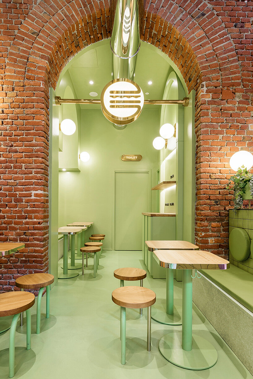 masquespacio combines brick arcs + bold colors within hamburger restaurant in milan