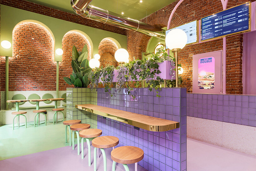 masquespacio combines brick arcs + bold colors within hamburger restaurant in milan