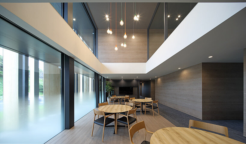 matsuyama architect and associates clads 'olive tree' group home with façade of angled timber louvers