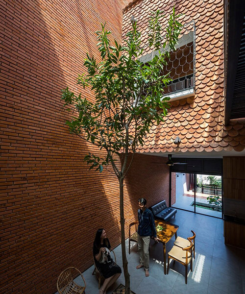 red brick and recycled fish scale tiles clad this family house by CTA in vietnam