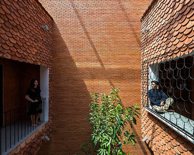 red brick and recycled fish scale tiles clad this family house by CTA in vietnam