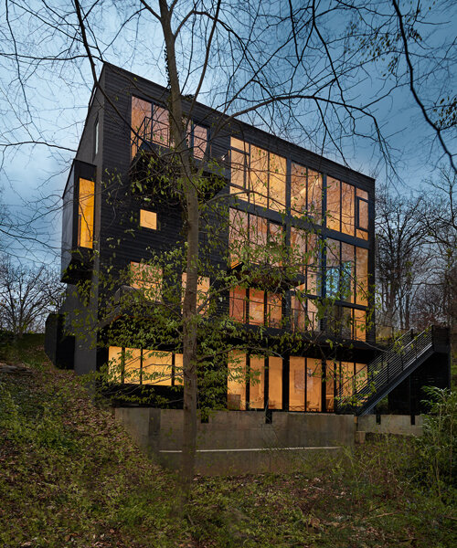 robert gurney architect's luminous facade opens toward its forested site