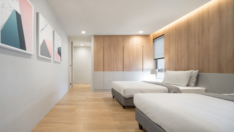 perspacetive renovates house in thailand with wooden battens + natural stone walls