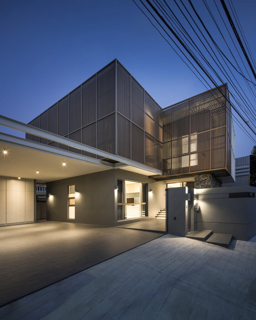 perspacetive renovates house in thailand with wooden battens + natural stone walls