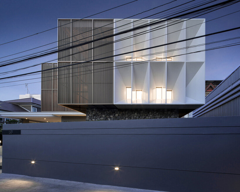 perspacetive renovates house in thailand with wooden battens + natural stone walls