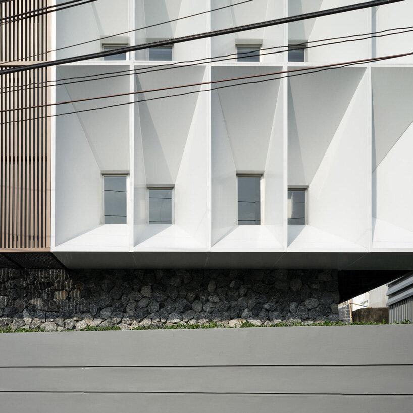 perspacetive renovates house in thailand with wooden battens + natural stone walls