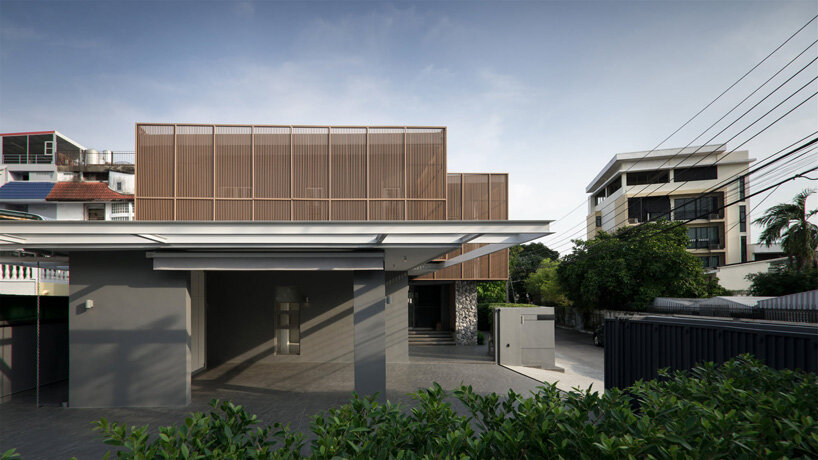 perspacetive renovates house in thailand with wooden battens + natural stone walls
