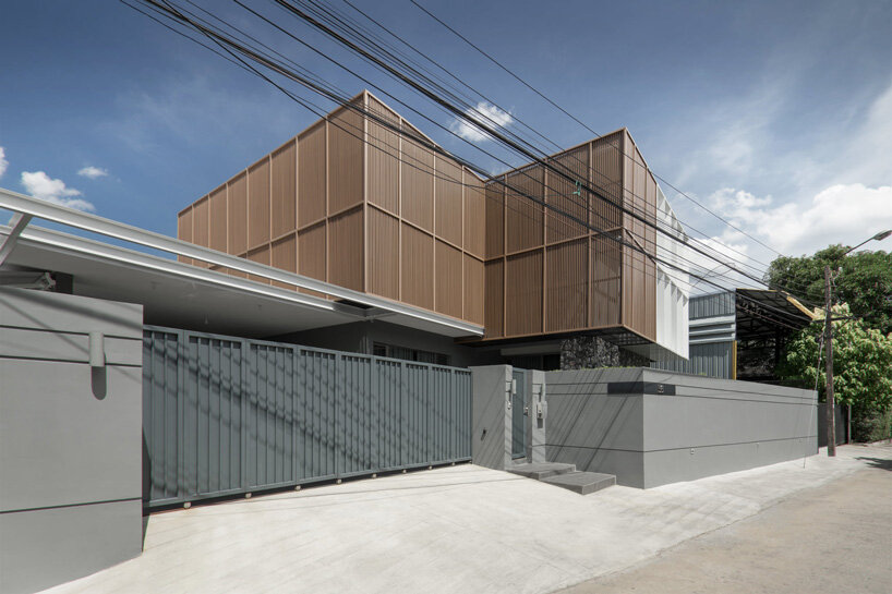 perspacetive renovates house in thailand with wooden battens + natural stone walls