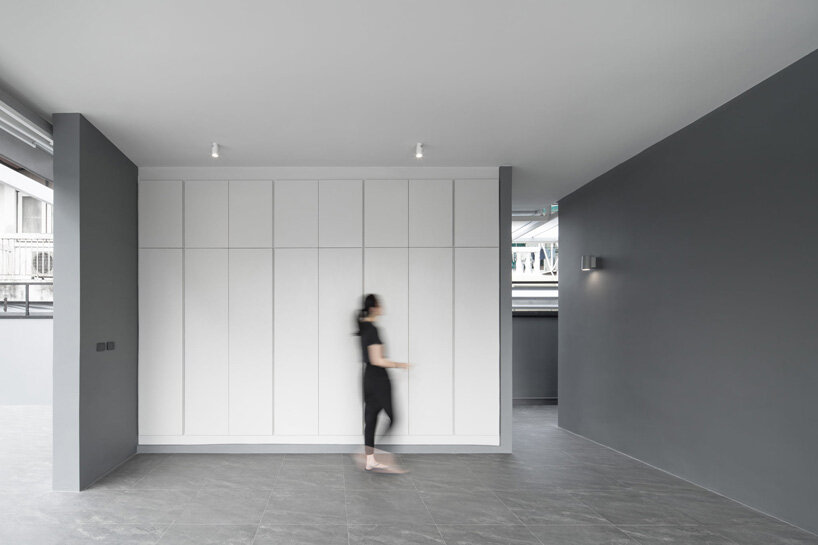 perspacetive renovates house in thailand with wooden battens + natural stone walls