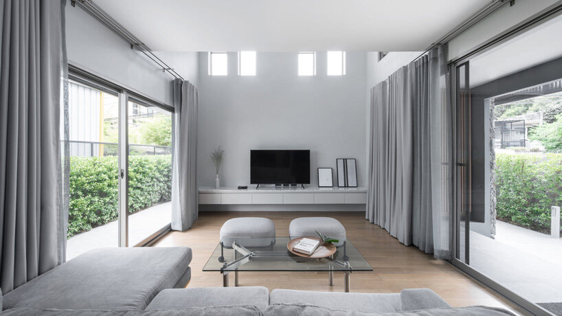 perspacetive renovates house in thailand with wooden battens + natural stone walls