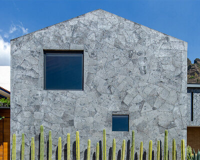 stone clad volumes form 'casa texcal' by HGR arquitectos within mexican countryside
