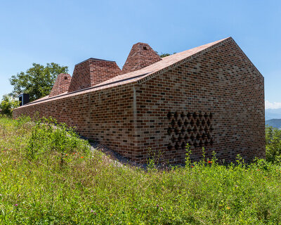 studioata embeds a faceted brick dwelling along the langhe hills of italy