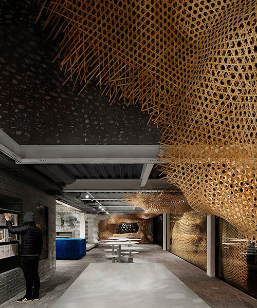 weaved bamboo installation by infinity mind extends within bookstore in shanghai