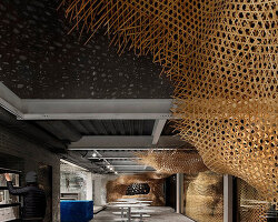 weaved bamboo installation by infinity mind extends within bookstore in shanghai