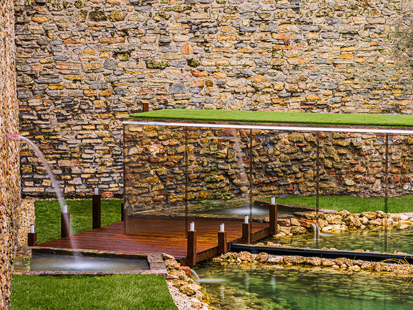 zoltan varro's mirrored spa occupies a 14th century castle moat in hungary