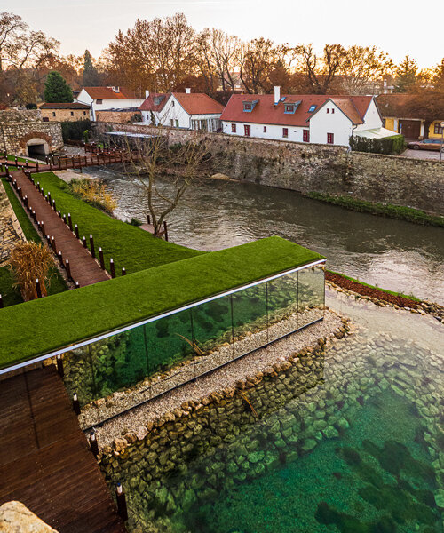 zoltan varro's mirrored spa occupies a 14th century castle moat in hungary