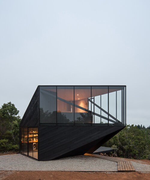 2DM's black timber-clad cabin points toward the sea on the chilean coastline