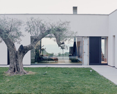 gabion cages filled with local stones support villa beusi's verdant terraces in italy