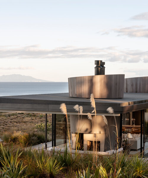 timber-clad cones divide a glass house in new zealand designed by cheshire architects