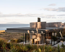 timber-clad cones divide a glass house in new zealand designed by cheshire architects