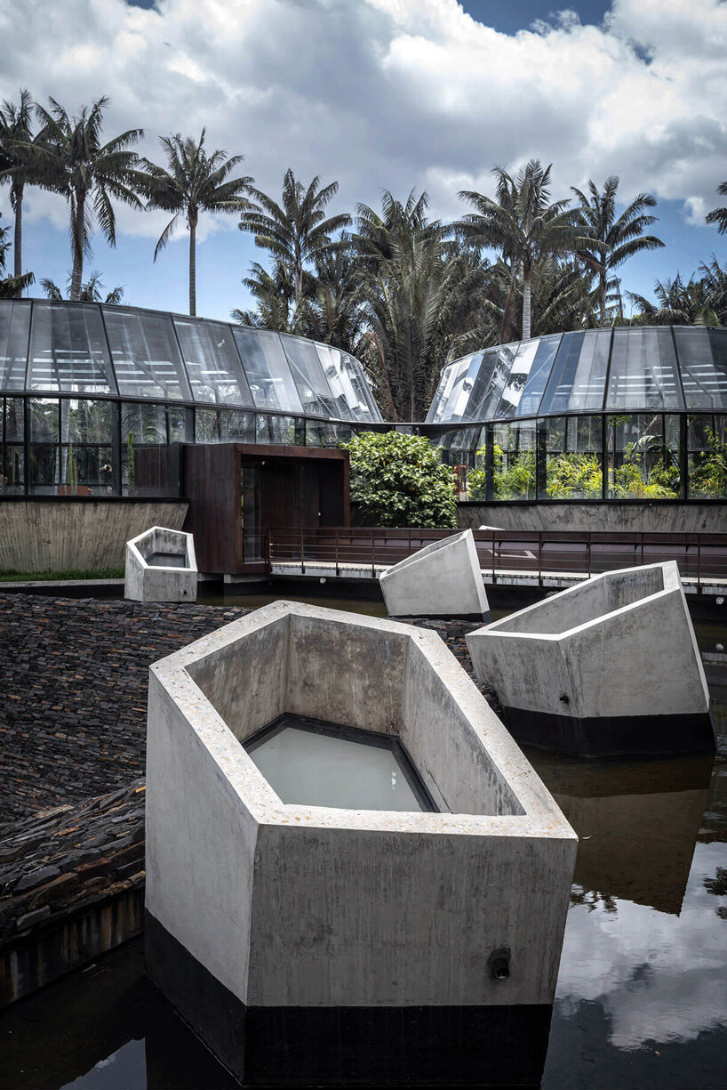 DARP blends cluster of floating glass volumes into the lush botanical garden of bogotá